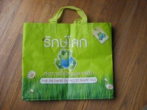 A re-usable Thai bag with the slogan "Save the Earth. Say No to Plastic Bags"